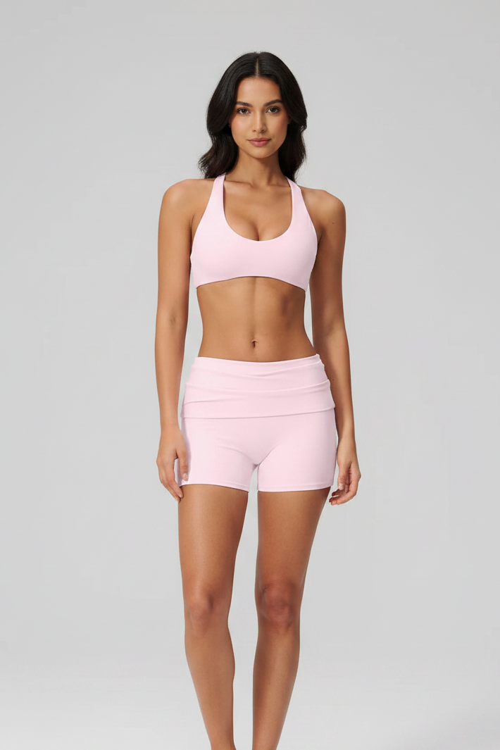 Front – pink cross-back sports bra with face